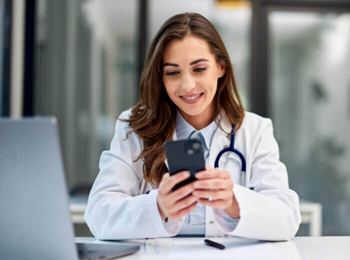 Girl on Phone Texting someone about healthcare revenue recovery