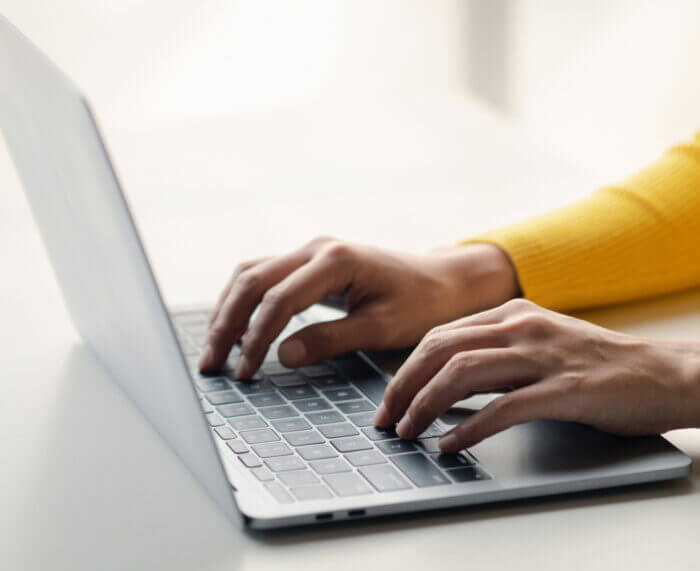 Hands on Laptop, researching Medicare underpayment recovery
