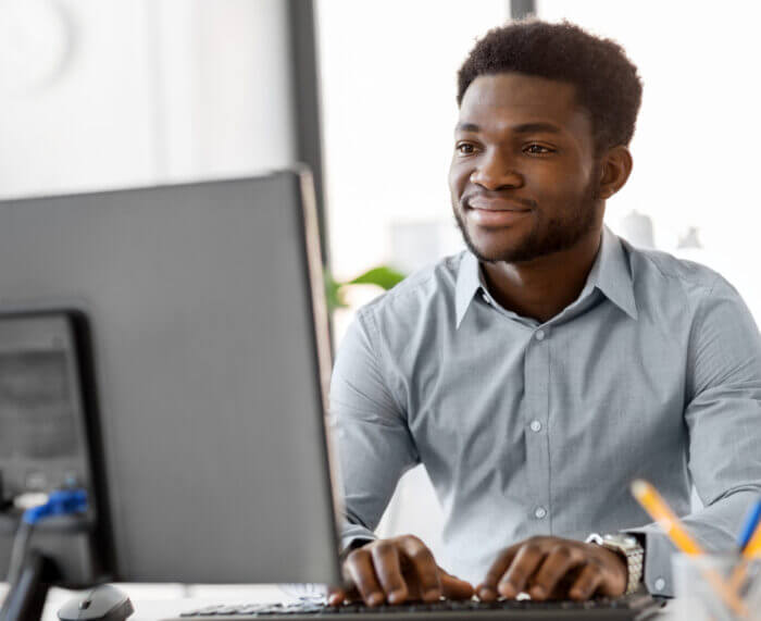 Man looking at computer researching insurance discovery services
