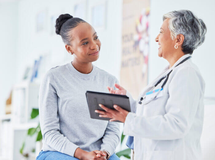 Patient with doctor while doctor explains patient payment processing